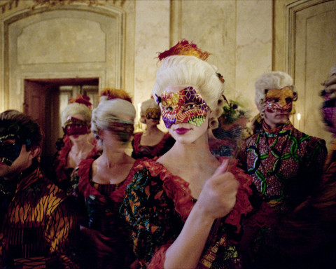 A masked woman at a masquerade 