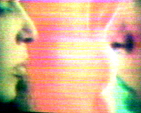 Film still with profiles of two people
