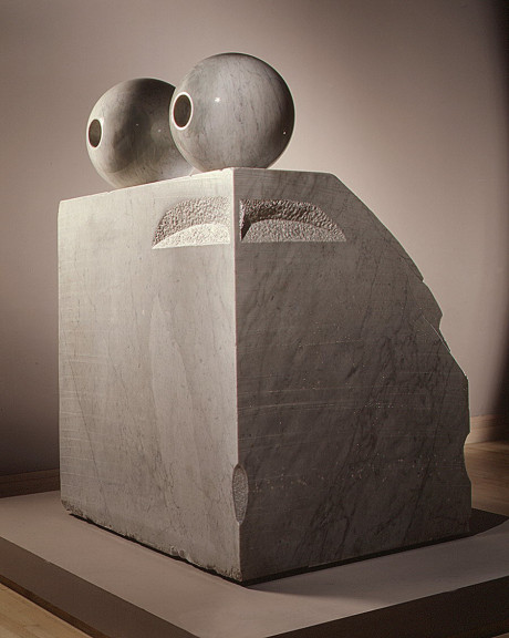 A large rectangular marble sculpture with spheres on top