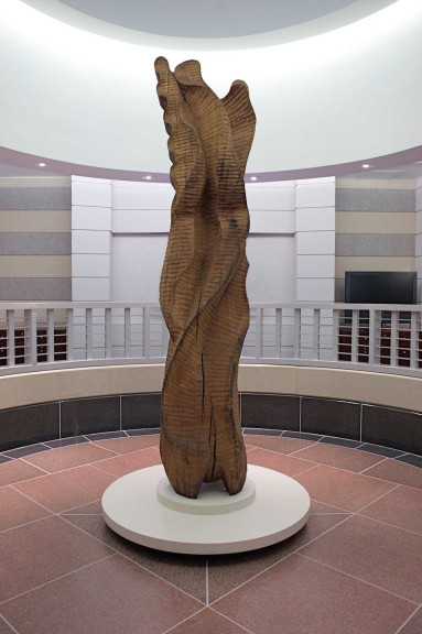 A cherry wood sculpture in a large rotunda