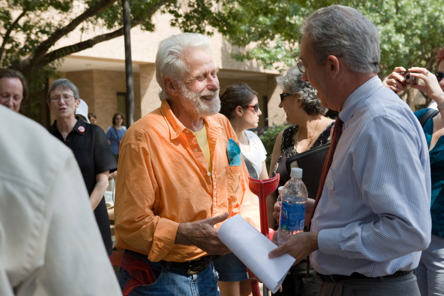 An older man talking to another man