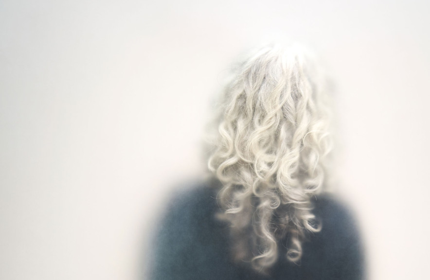 A woman with curly silver hair
