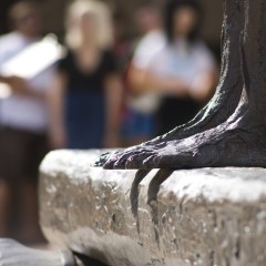 Feet of a statue on top of a horizontal beam
