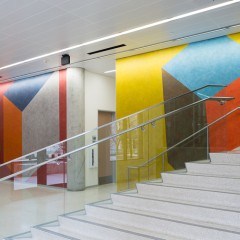 A wall drawing in front of a stairwell