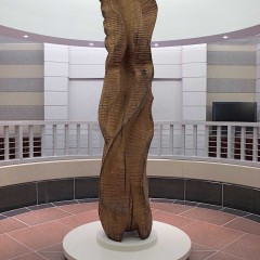 A cherry wood sculpture in a large rotunda