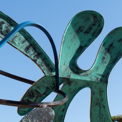A detail of the sculpture that is amoebic in shape and painted green
