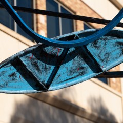 A detail of the sculpture that is almost almond shaped which streches across the whole image plane, a zigzag cuts across the shape which is painted blue.