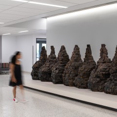 An installation view of Seven mountain shaped objects made from wood blocks
