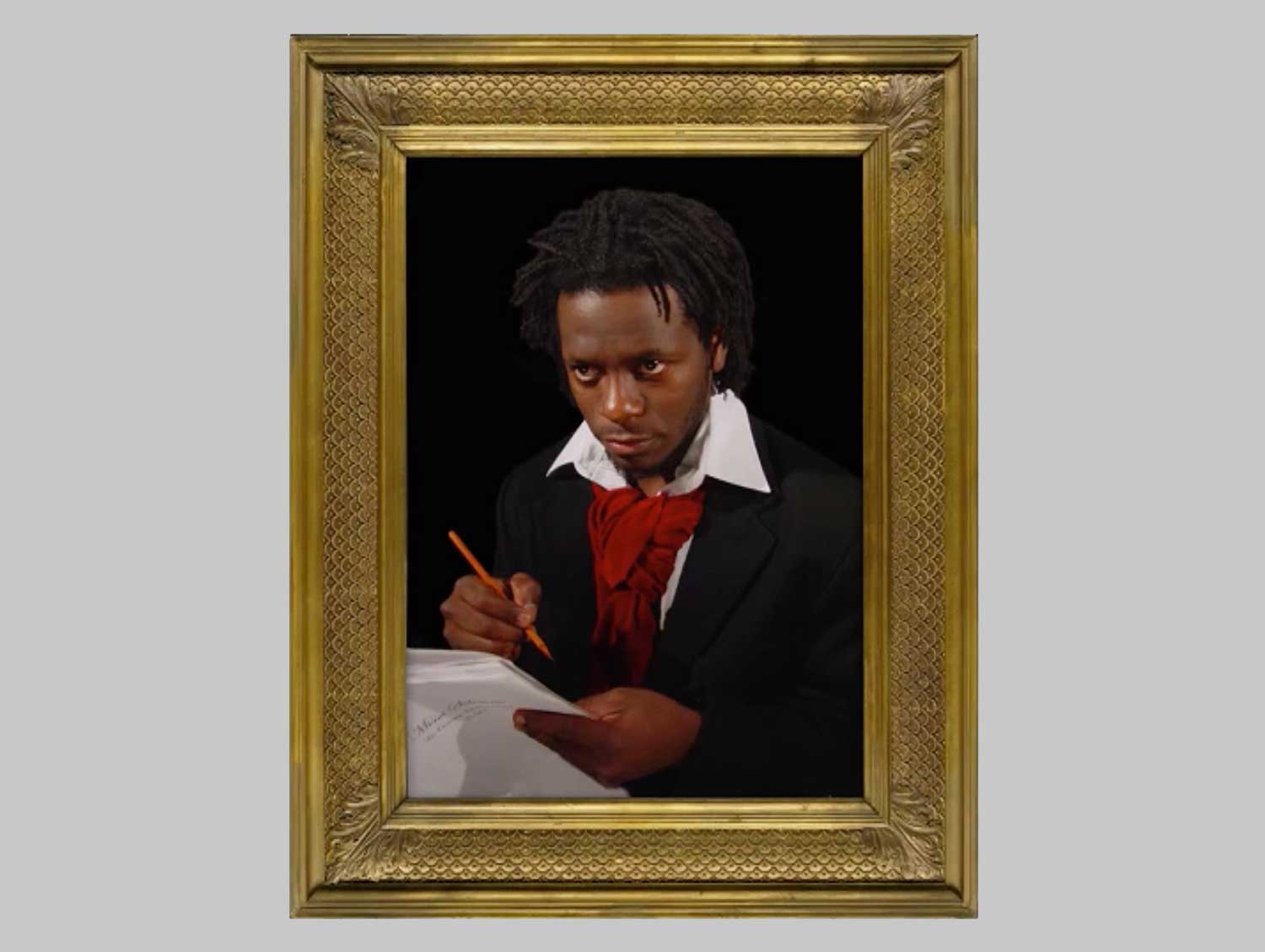 A picture frame around a man holding a writing utensil