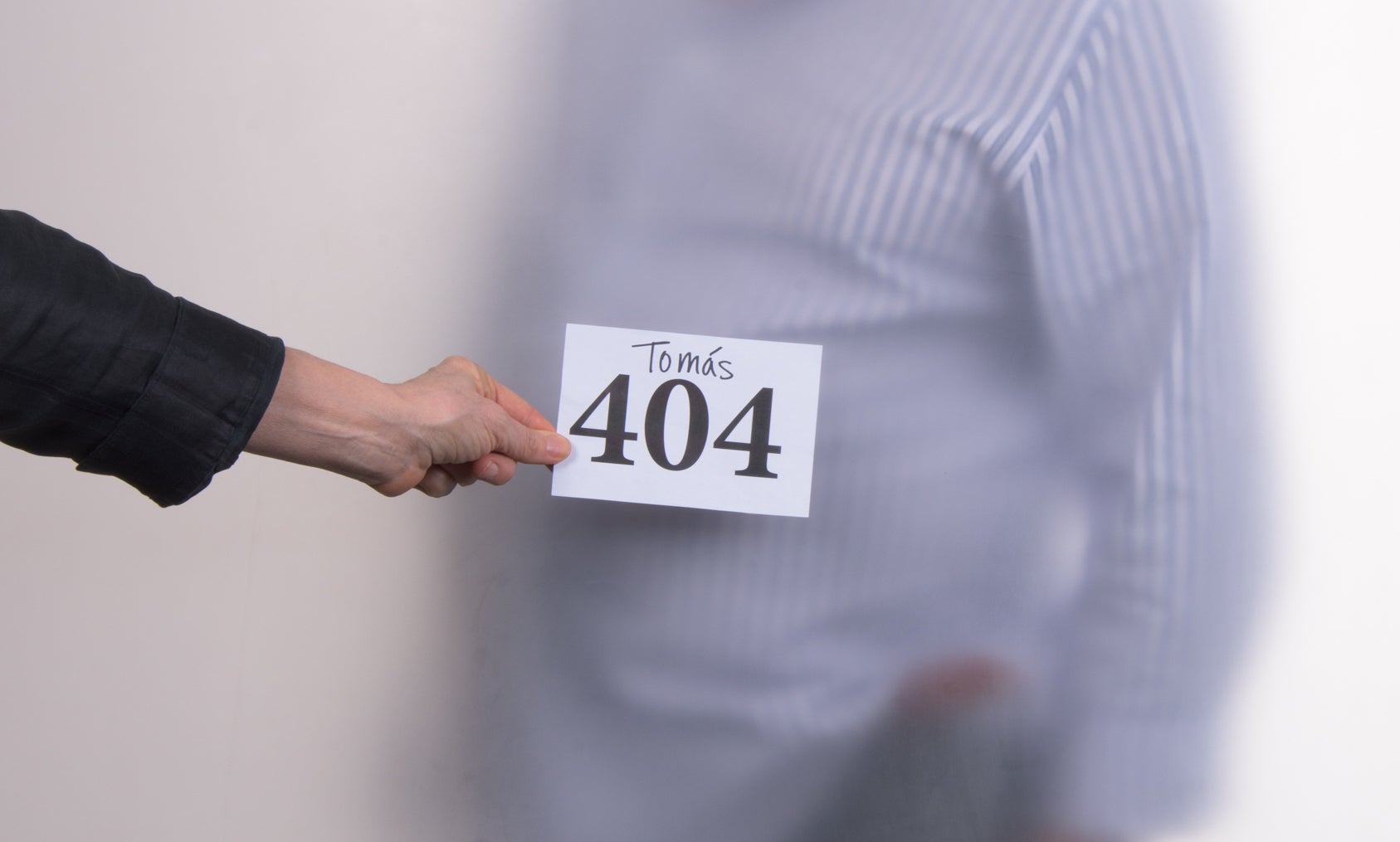 404 sign in front of man standing behind screen