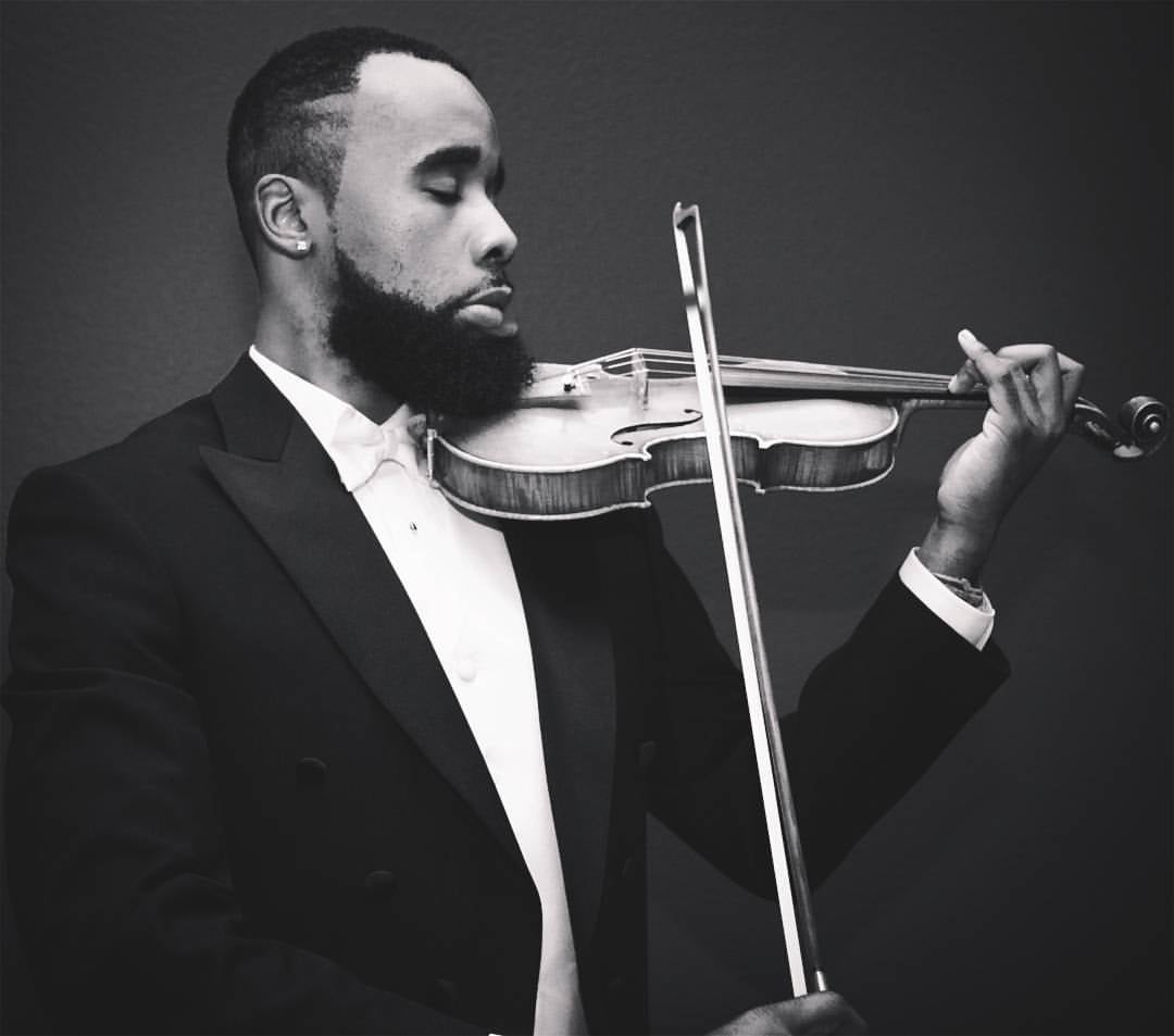 A black and white photo of Shawn LeSure playing Violin.