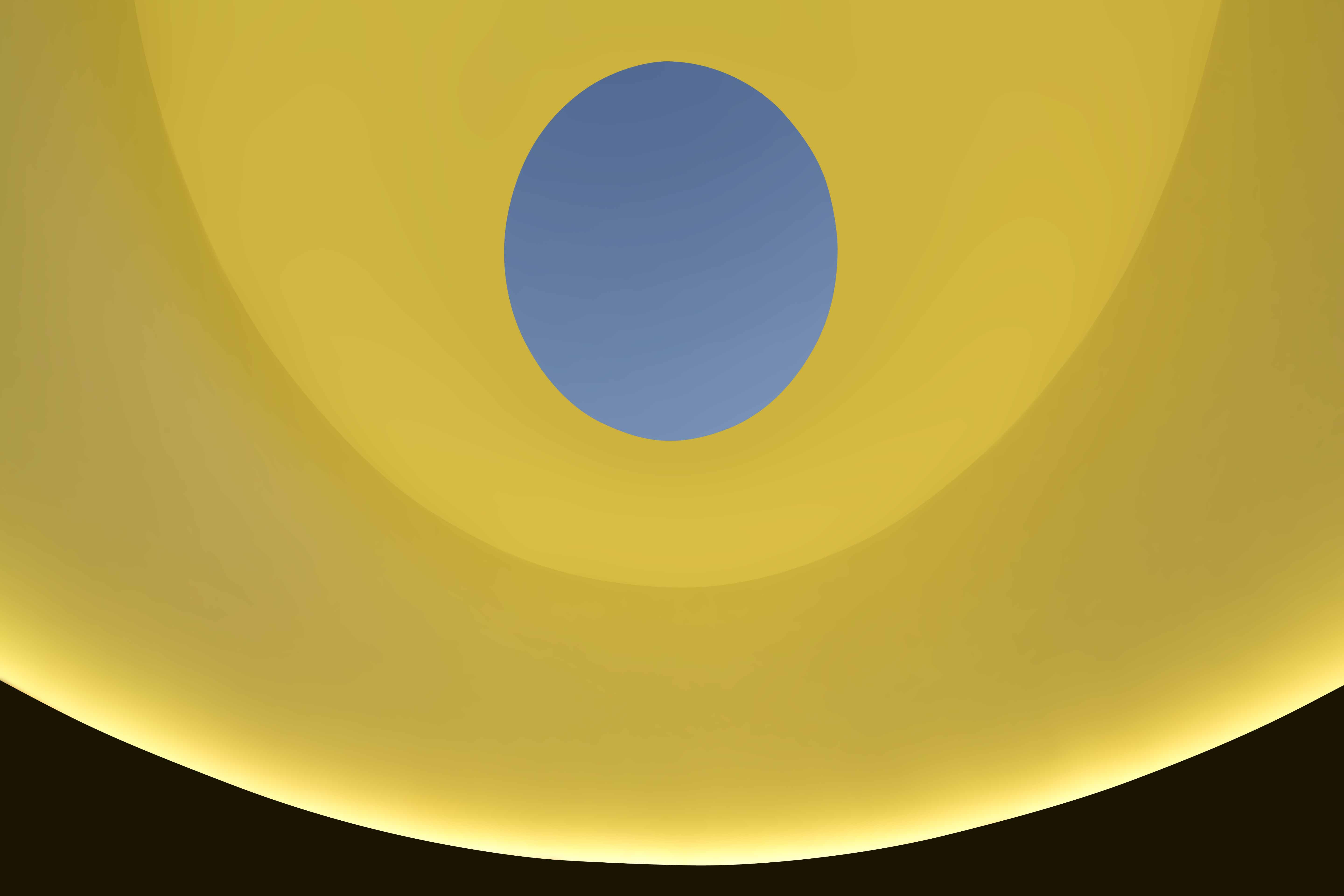 An image of the interior of James Turrell's skyspace with yellow color lighting the walls, turning the visible sky blue through the oculus.