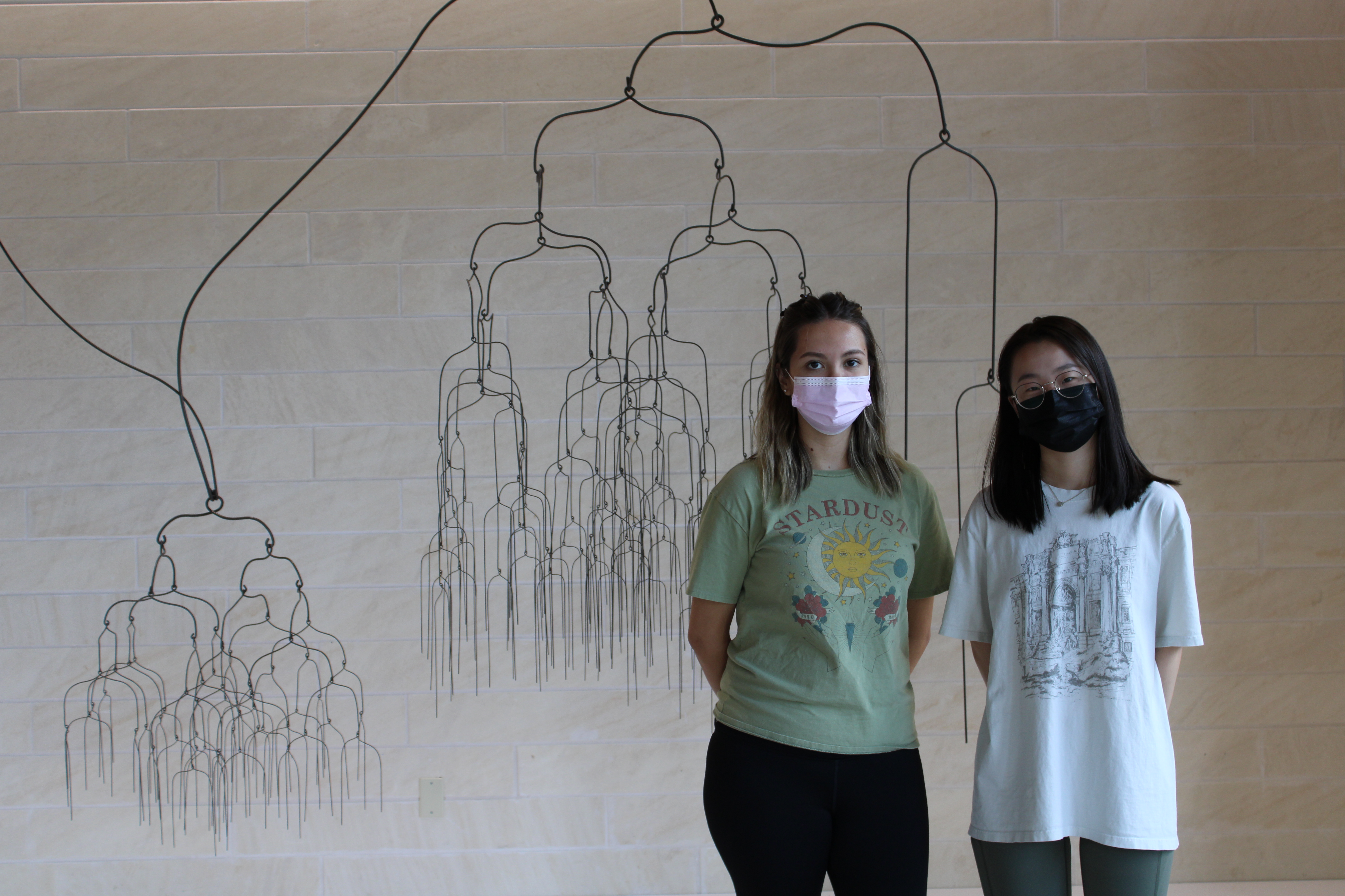 Two students stand in front of Beth Campbell's "Spontaneous Future(s), Possible Past(s)."