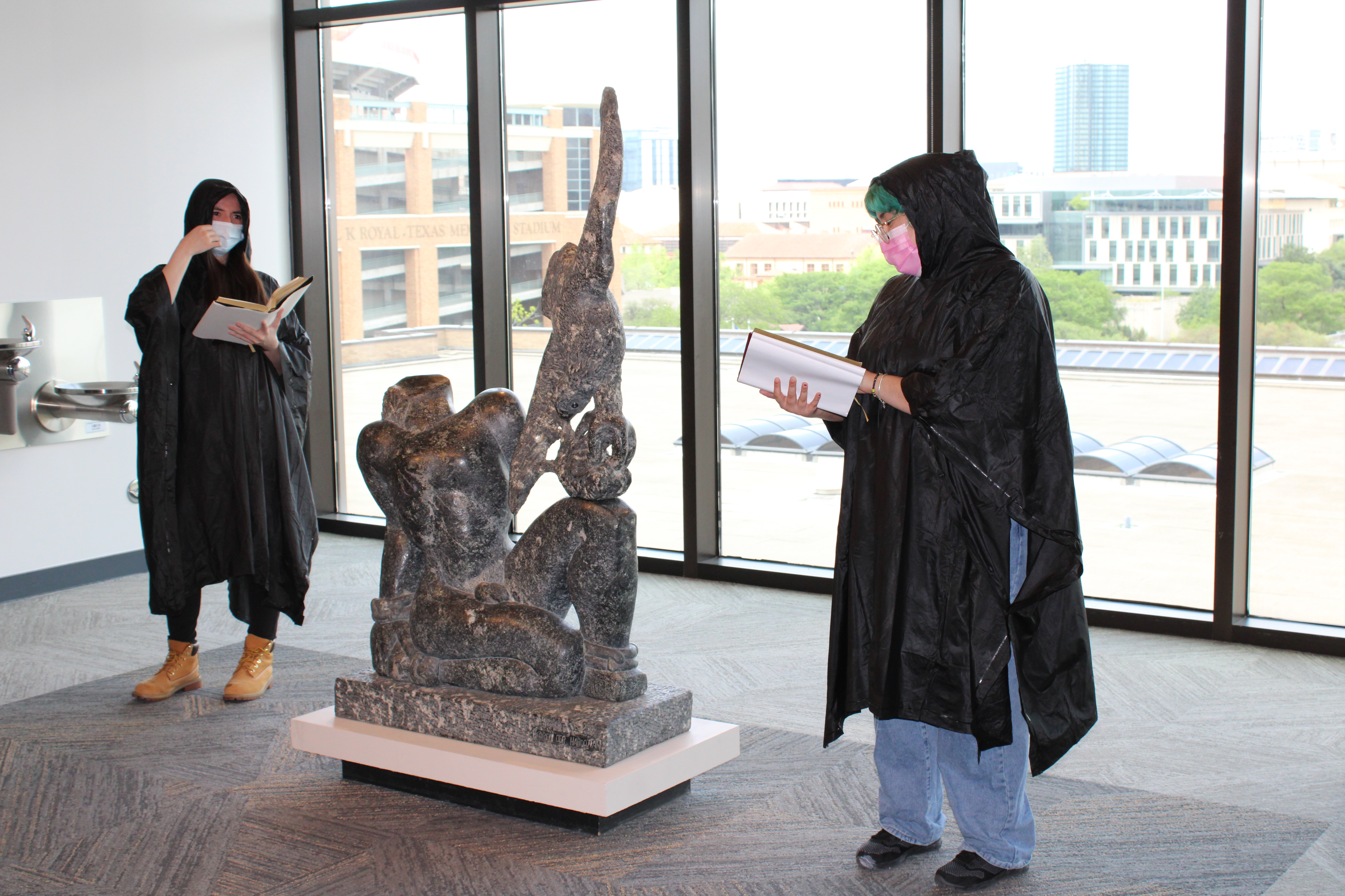 Two students dressed as a "greek chorus" reveal the myth of Prometheus and the Vulture 