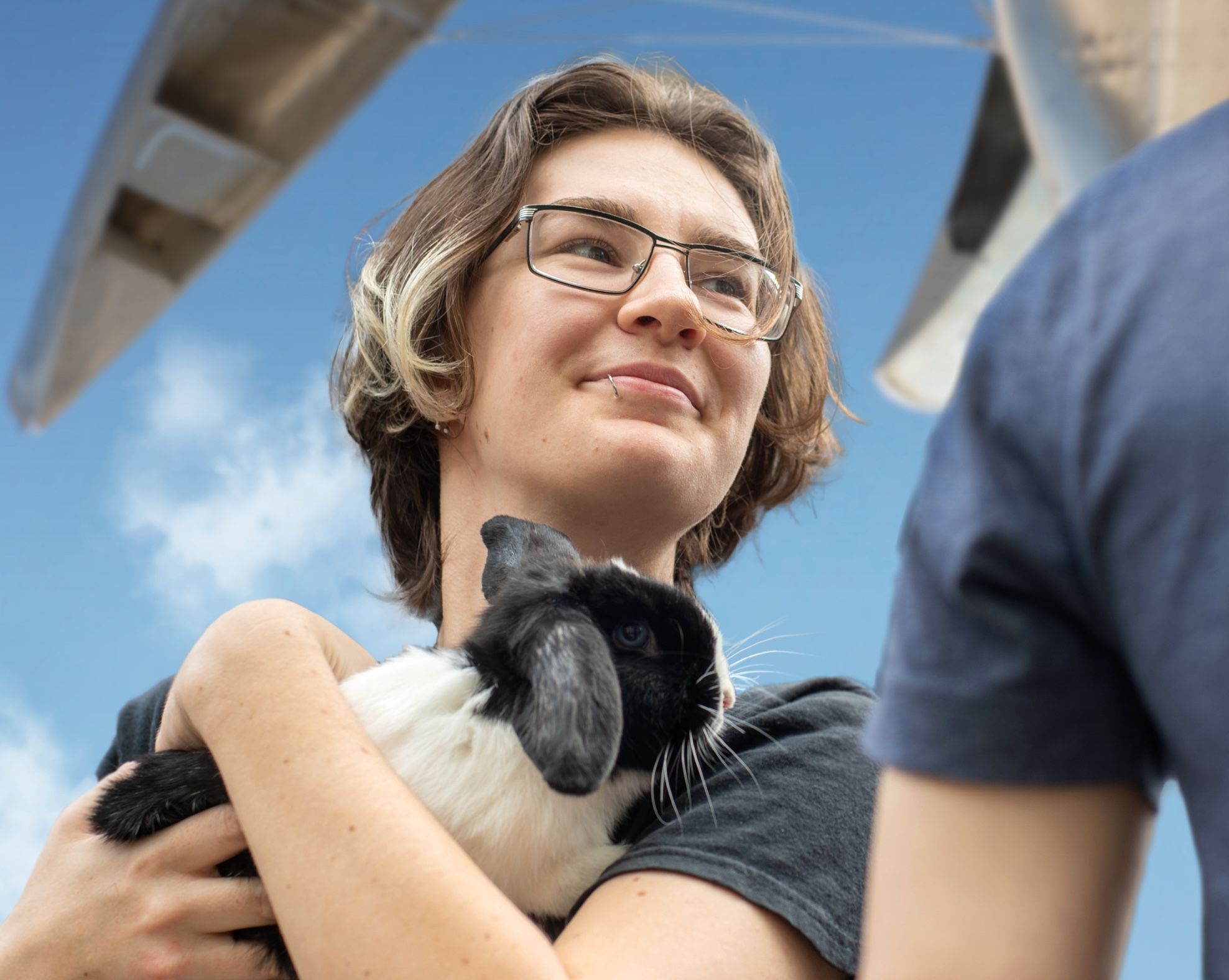 A student holds a rabbit at Paws for Public Art