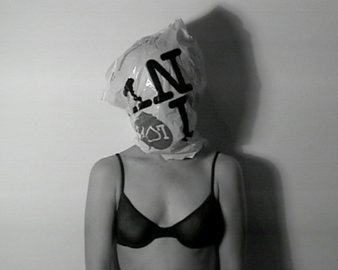 A woman in a bra with a plastic bag over her head