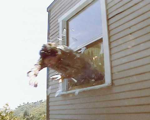 A man jumping out of a window.