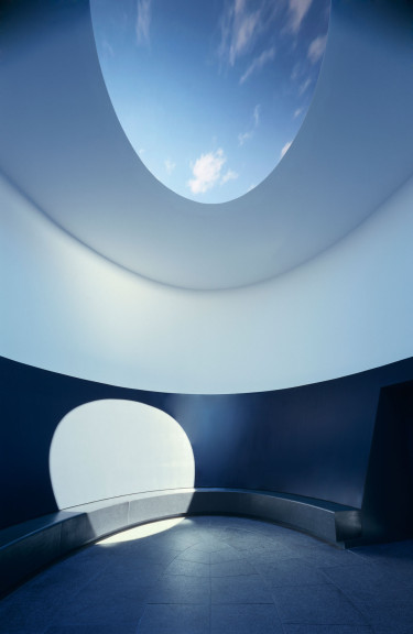 Lighting shining through an oculus into a cylindrical room