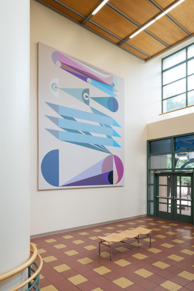 An image of Eamon Ore-Giron's "Tras los ojos," a large digital print which hangs in the atrium of a building.