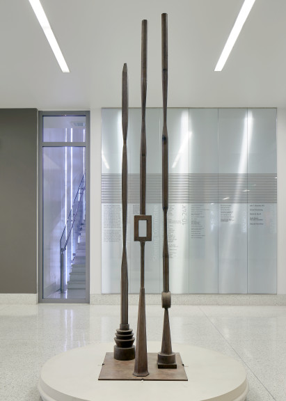 Tall sculpture with three large vertical poles