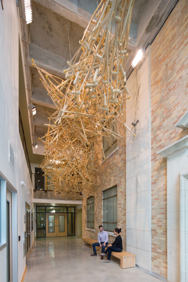 Wooden crutches hanging from a ceiling with two people under it