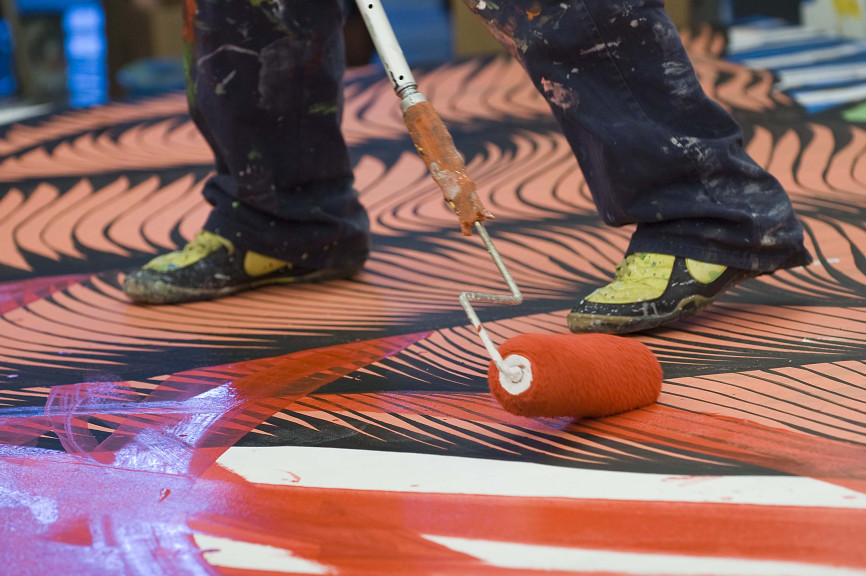 roller of paint and feet on surface