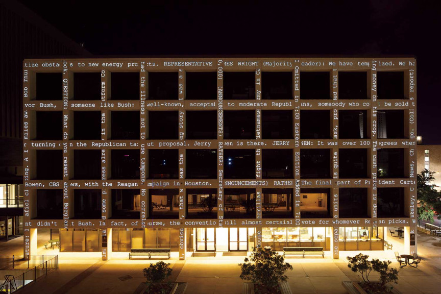 A brutalist building with text along the support structures