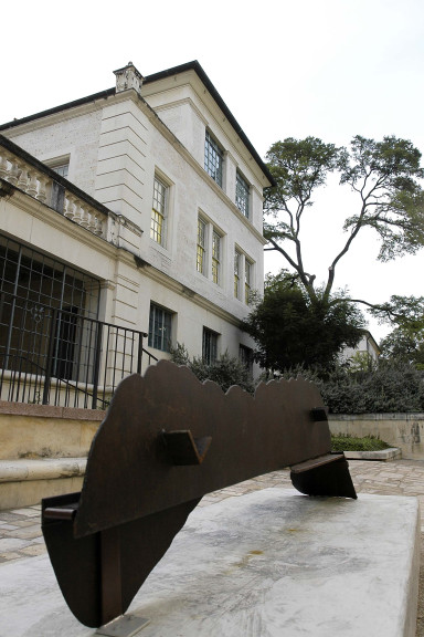 brown bench shaped sculpture on base