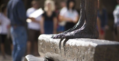 Feet of a statue on top of a horizontal beam