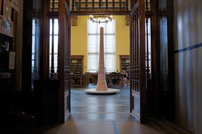 A marble sculpture in the doorway of a large room