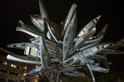 cluster of canoes lit up against black sky
