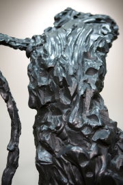 Detail of a curved sculpture on a base