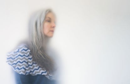 A woman with long grey and white hair