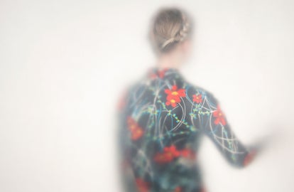 A woman in a patterned shirt