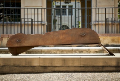 A brown sculpture on a concrete base