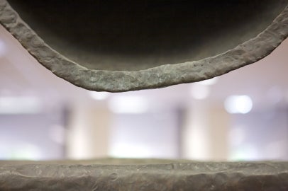 A metal half circle with a flat metal bottom