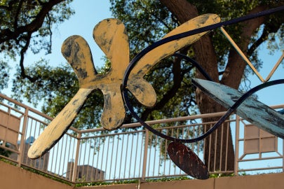 A detail of the sculpture that is amoebic in shape and painted yellow