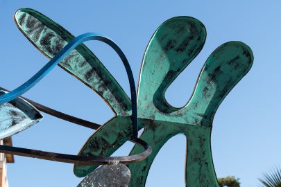 A detail of the sculpture that is amoebic in shape and painted green