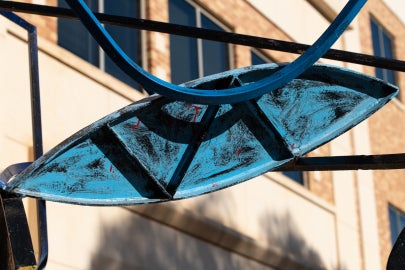 A detail of the sculpture that is almost almond shaped which streches across the whole image plane, a zigzag cuts across the shape which is painted blue.