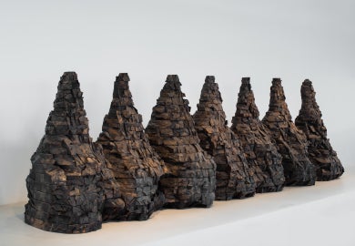 Seven mountain shaped objects made from wood blocks