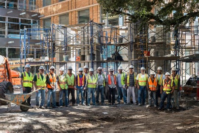 people grouped together in front of outdoor structure
