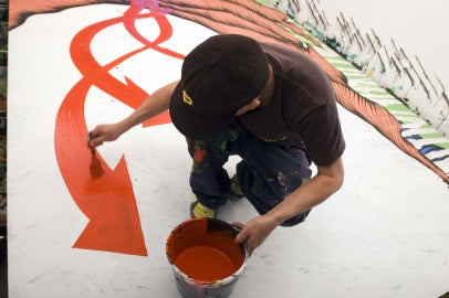 person holding paint can