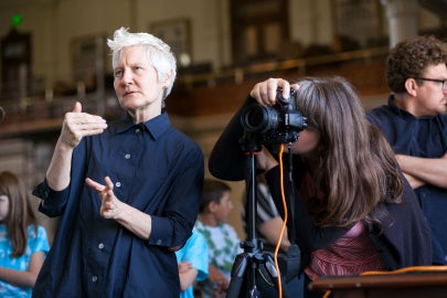 A woman next to a camera