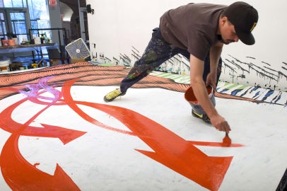 person painting red and white surface