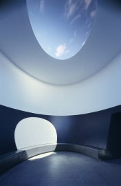 room with hole in ceiling with sun shining through