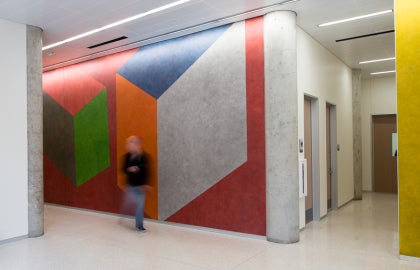 man walking by colorful wall