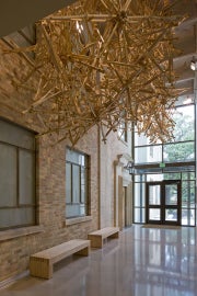 A hanging sculpture made out of wooden crutches