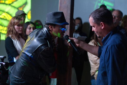 person holding microphone for someone to speak into it