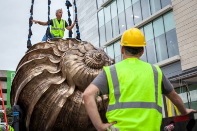 A man standing on top of a bronze shell