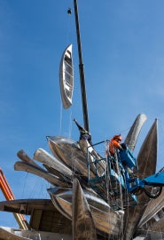 crane holding canoe in air